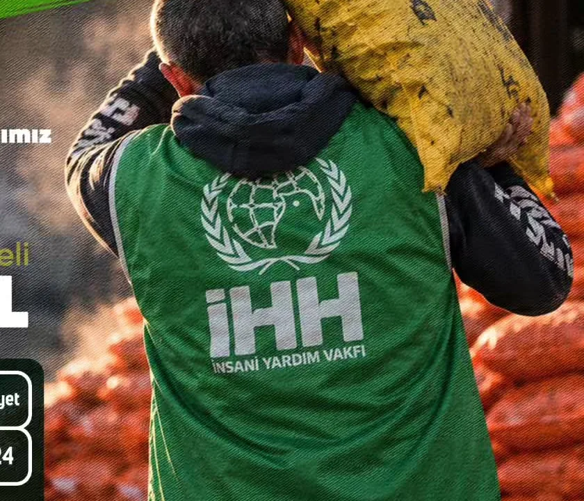 Sırtında kömür çuvalı taşıyan İHH gönüllüsü